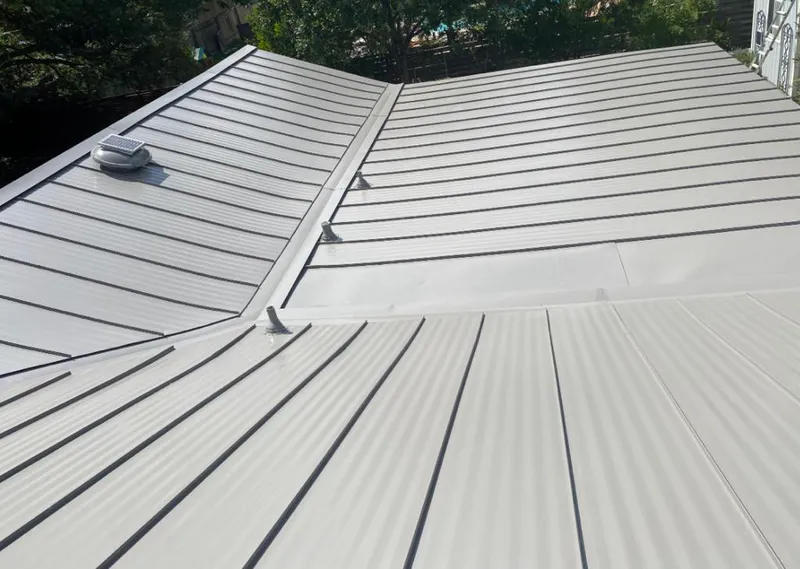 Solar attic fan installed on a metal roof for Roof Ventilation in Runnemede