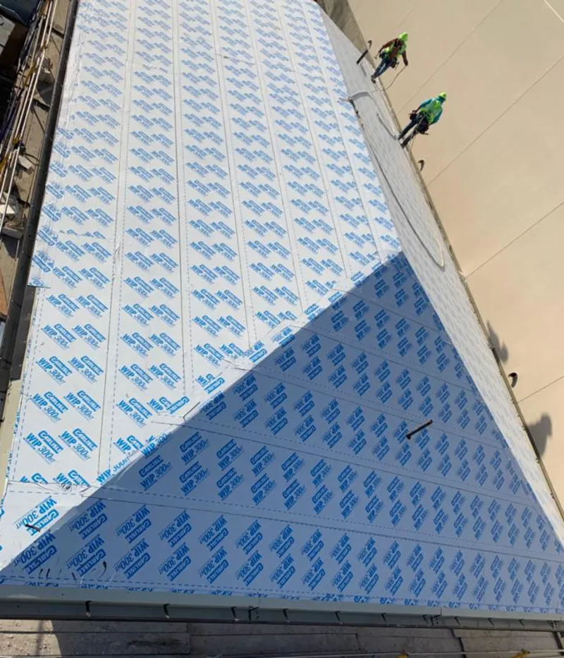 Professional roofers installing underlayment on a metal roof in Runnemede